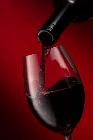 Pour the wine into a wine glassの写真素材