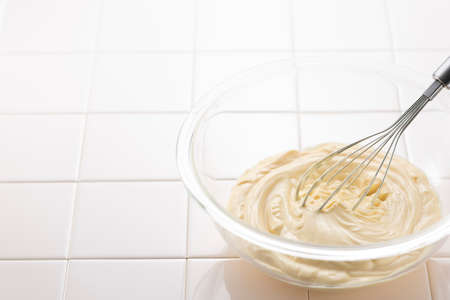 Mix homemade mayonnaise in a bowl.の写真素材