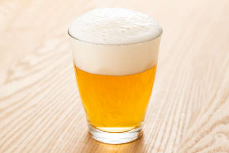 Pour non-alcoholic beer into a glass.