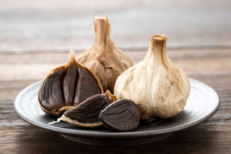Black garlic, health food made by fermenting garlic.の写真素材
