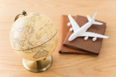 Airplane model and globe on wooden desk.の写真素材