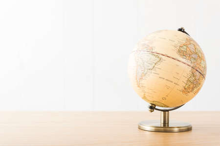 Retro globe on wooden desk.の写真素材