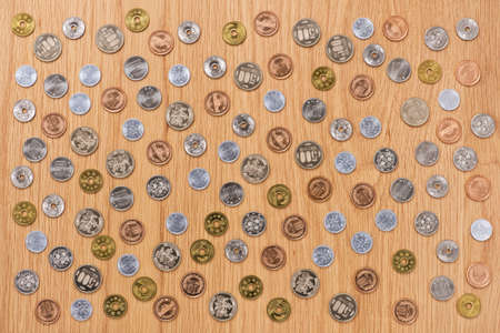 Japanese yen coins on wood table.