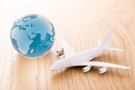 Airplane model and globe on wood table.の写真素材