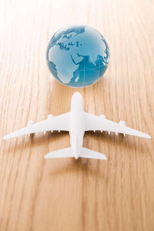 Airplane model and globe on wood table.の写真素材
