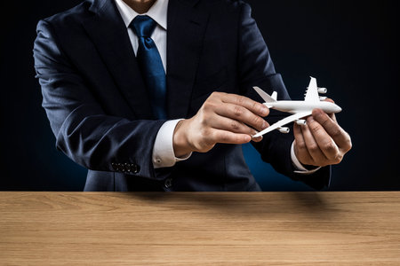 Man holding an airplane model in his hand.の写真素材