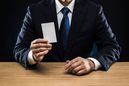 Businessman with business card, holding in hand.の写真素材