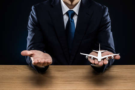 Man holding an airplane model in his hand.の写真素材