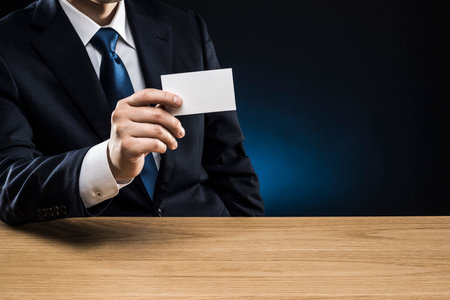 Businessman with business card, holding in hand.の写真素材