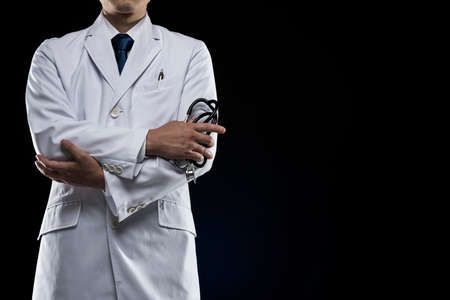 Doctor in lab coat on black background.