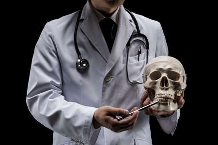 Doctor in lab coat on black background.