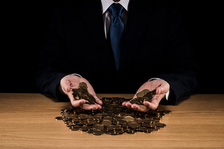 Man holding a pile of coins.の写真素材