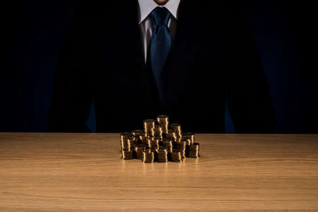 Man holding a pile of coins.の写真素材