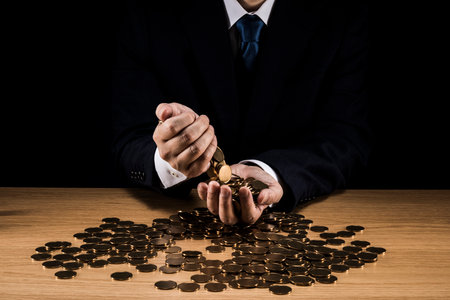 Man holding a pile of coins.の写真素材