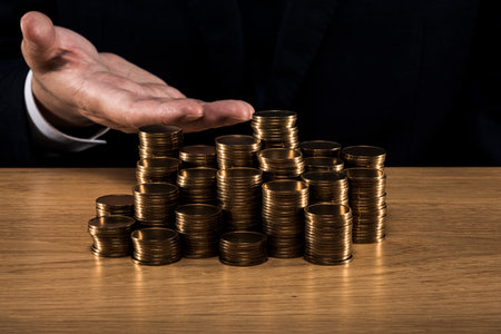 Man holding a pile of coins.の写真素材