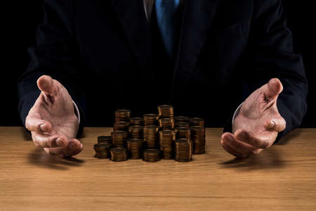 Man holding a pile of coins.