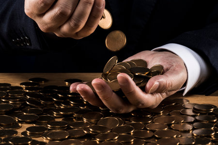 Man holding a pile of coins.の写真素材