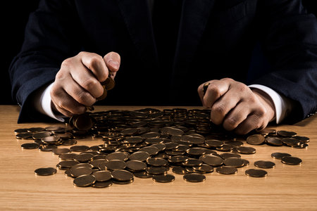 Man holding a pile of coins.の写真素材