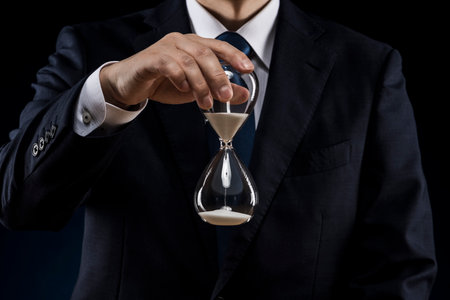 Businessman with hourglass in hand.の写真素材