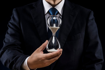 Businessman with hourglass in hand.の写真素材