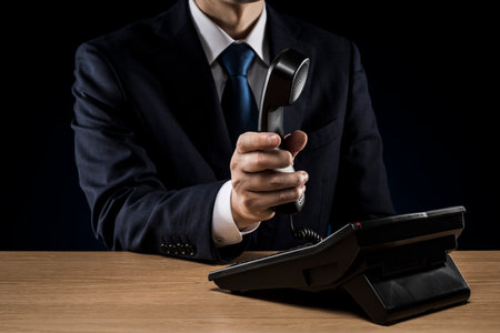 Businessman with business phone on desk.の写真素材