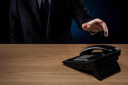 Businessman with business phone on desk.の写真素材
