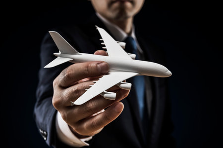 Man holding an airplane model in his hand.の写真素材