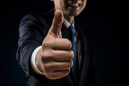 Businessman in a suit thumbs up.の写真素材