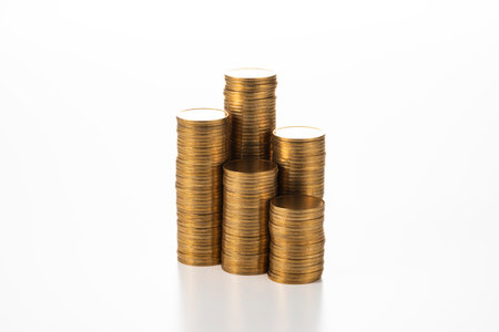 Stacked coins on white background.の写真素材