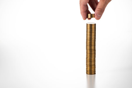 Stack a lot of coins. White background.の写真素材