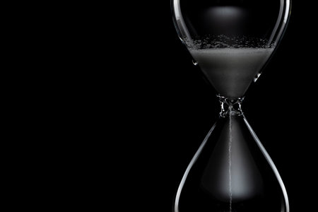 Close up of hourglass on black background.の写真素材