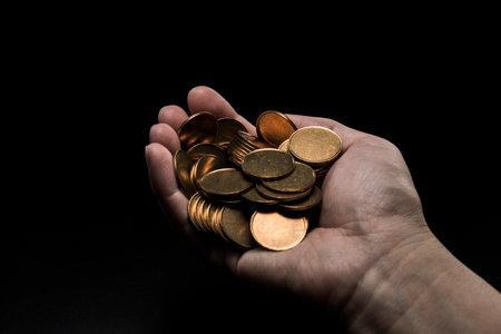 Man with a lot of coins in his hand.