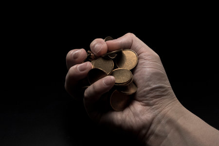 Man with a lot of coins in his hand.