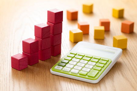 Colorful blocks and calculator on wood table.の写真素材