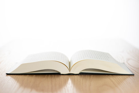 Open thick book on wood table.の写真素材