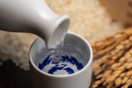 Cold sake with rice and ear of rice  on the tableの写真素材