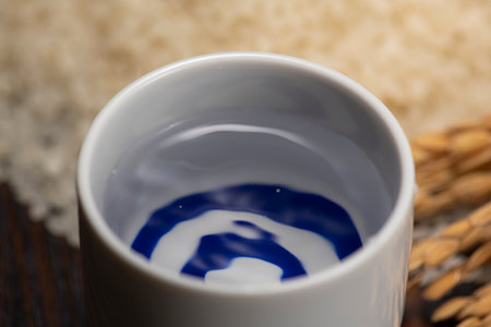 Cold sake with rice on the tableの写真素材
