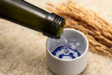 Cold sake with rice and ear of rice  on the tableの写真素材