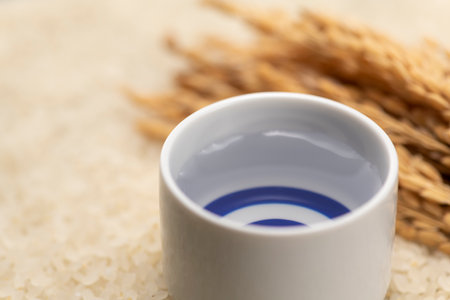 Cold sake with rice and ear of rice  on the tableの写真素材