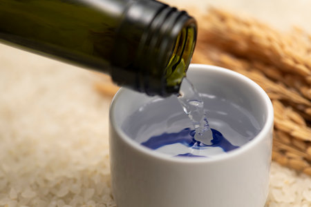 Cold sake with rice and ear of rice  on the tableの写真素材