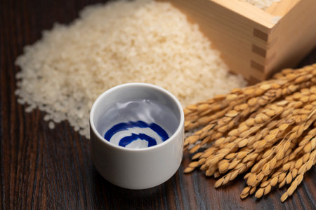 Cold sake with rice and ear of rice  on the tableの写真素材