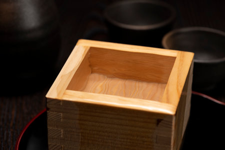 Sake overflows from the square cupの写真素材