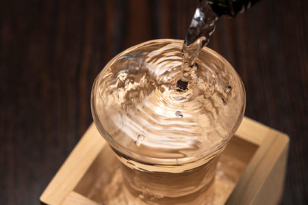 Sake overflows from the square cupの写真素材