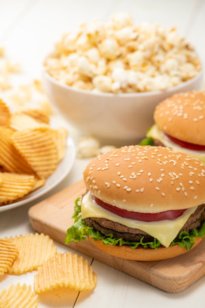<p>Junk food image. Hamburger with french fries, potato chips and popcorn.</p>の写真素材