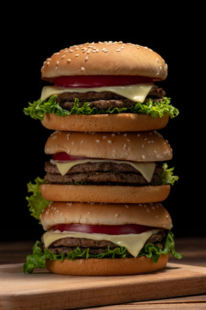 Hamburger stacked on a dark table backgroundの写真素材