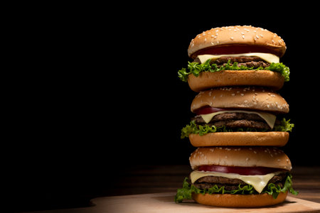 Hamburger stacked on a dark table backgroundの写真素材