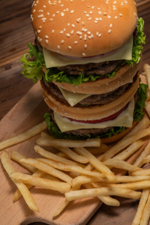 Hamburger stacked on a dark table backgroundの写真素材