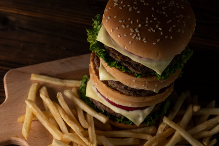 Hamburger stacked on a dark table backgroundの写真素材