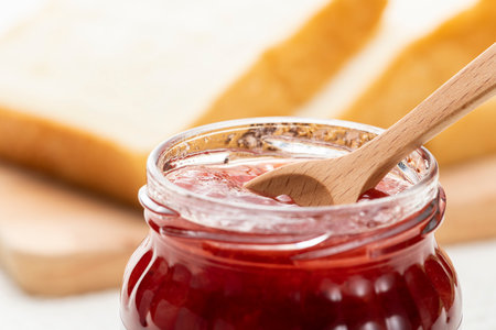 Strawberry jam in a bottle on the tableの写真素材