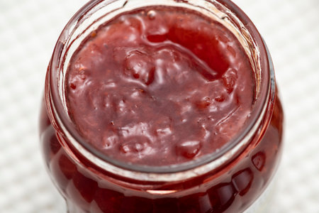 Strawberry jam in a bottle on the tableの写真素材